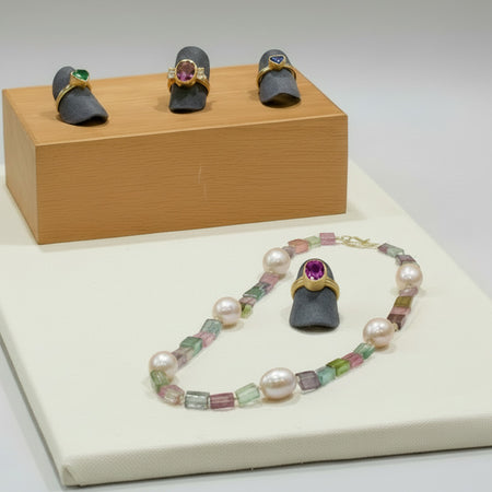 Confetti Necklace with Kunzite, Emerald, Raspberry Tourmaline, and sapphire triangle rings.