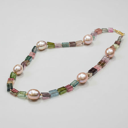Rock Candy Necklace with tourmaline rectangle beads and pearls on a beige background