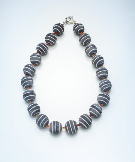 Necklace with gray and orange yellow beads on a white background